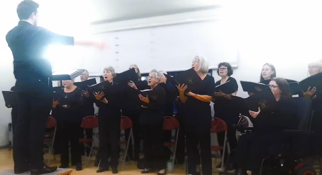 Choir singing with conductor